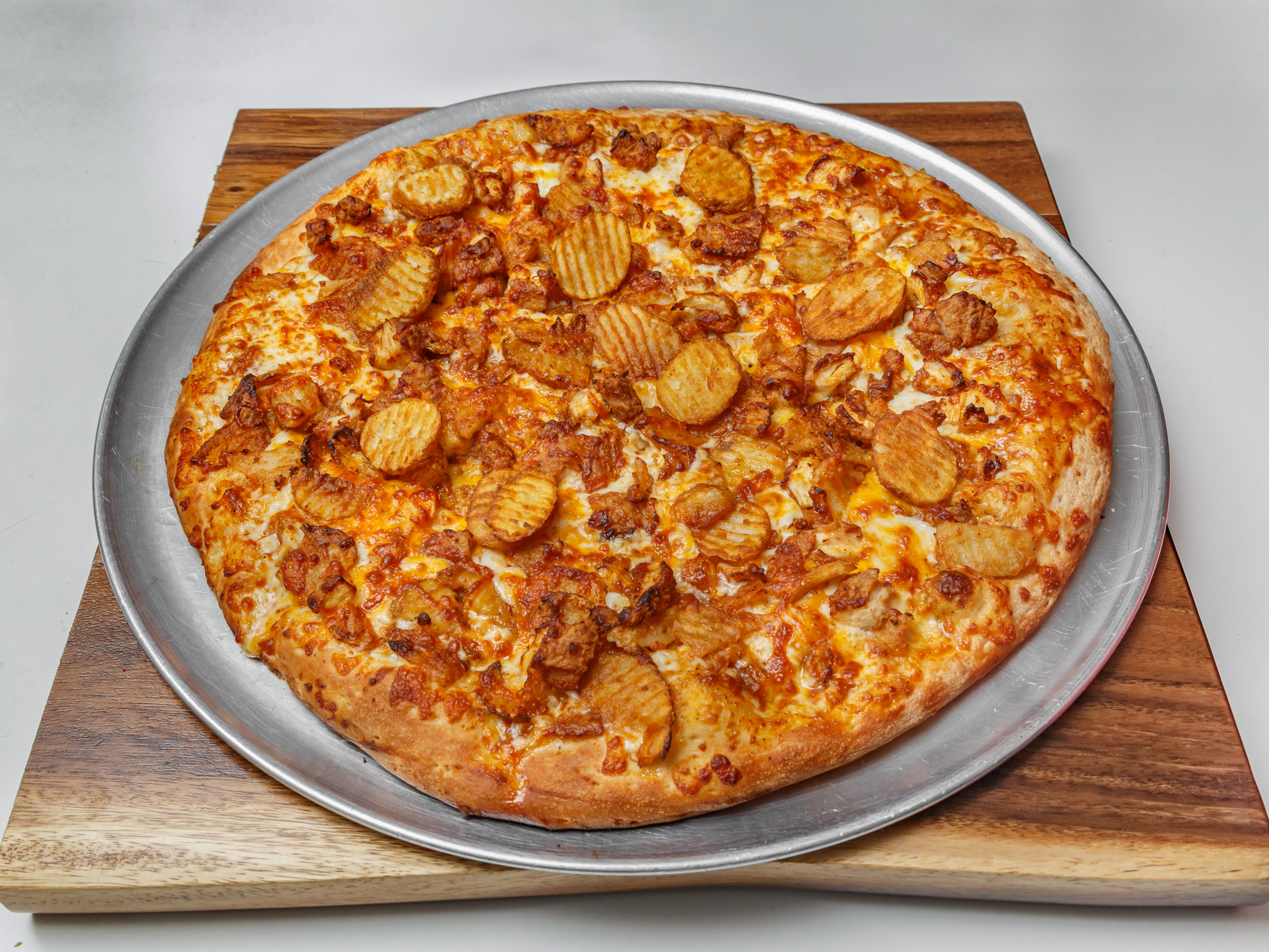 Buffalo chicken pizza with buffalo fries and cheddar cheese, a Pittsburgh favorite from Pizza Perfectta Shadyside