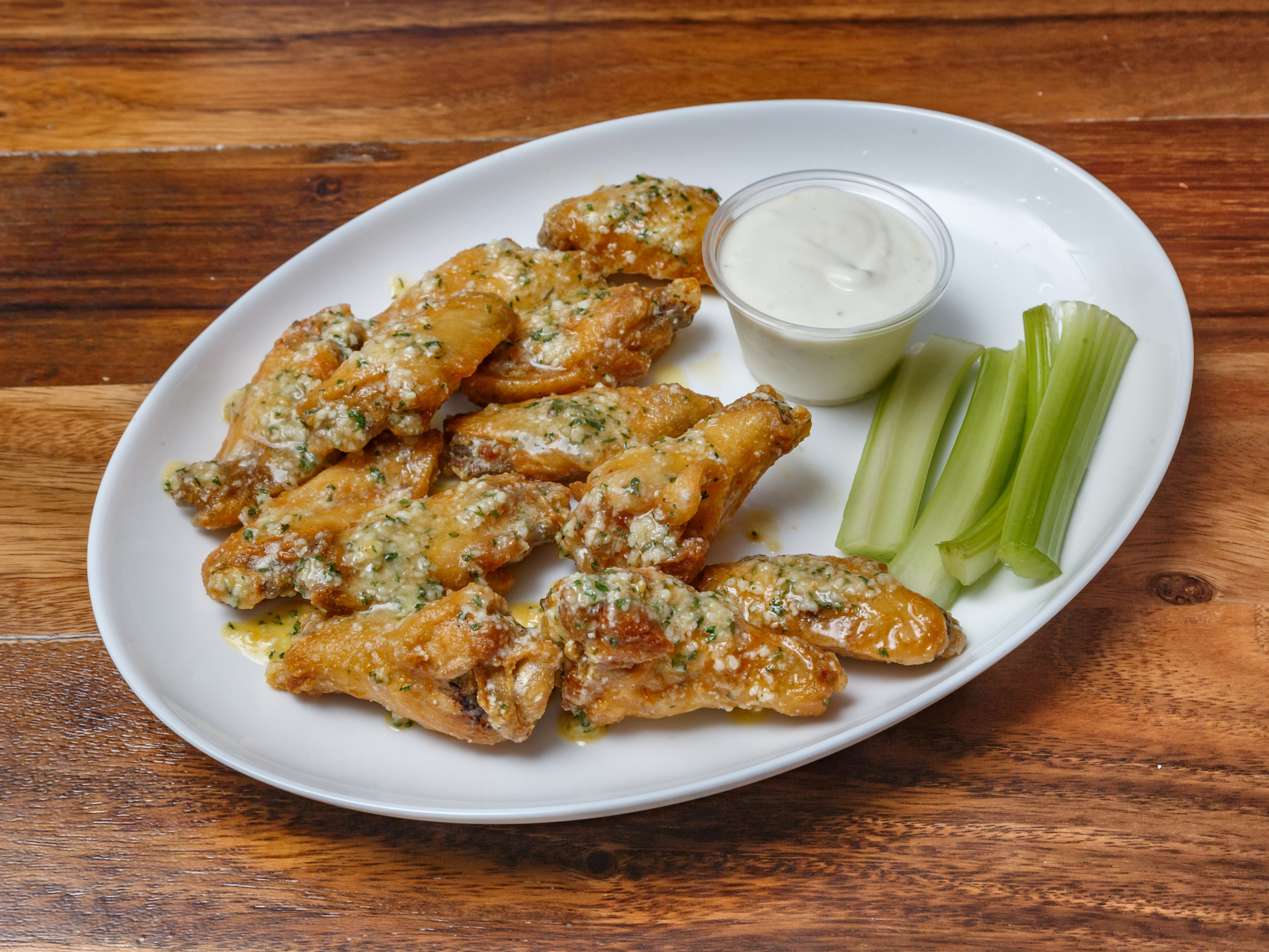 Garlic parmesan wings tossed in buttery garlic sauce, a specialty item at Pizza Perfectta Pittsburgh